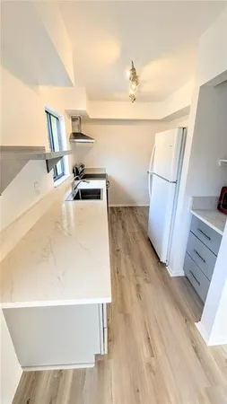 a kitchen with a sink a stove and a refrigerator