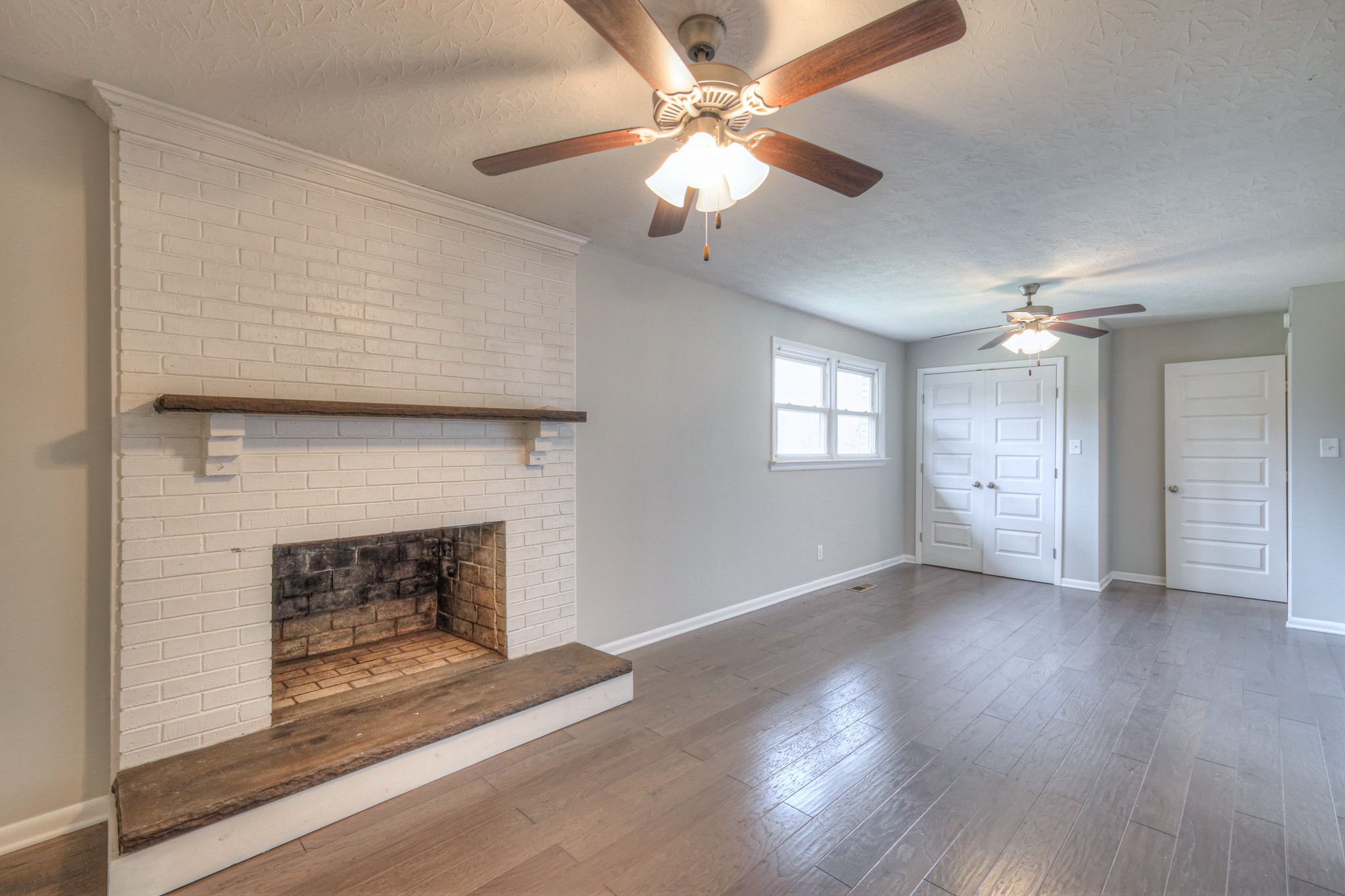 320 Ramsey Road Lebanon, TN 37087 - Photo 11 of 28 a view of an empty room with wooden floor fireplace and a window