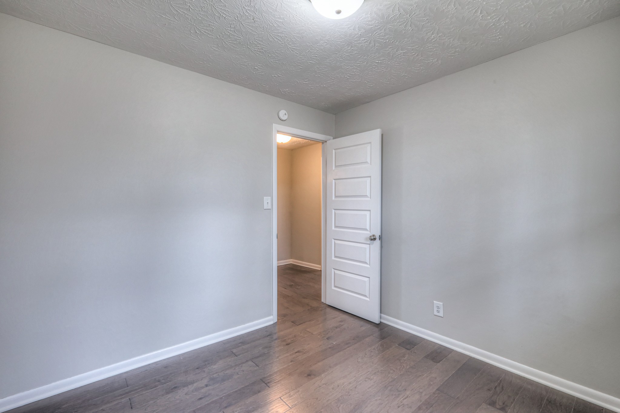 320 Ramsey Road Lebanon, TN 37087 - Photo 16 of 28 an empty room with wooden floor and windows