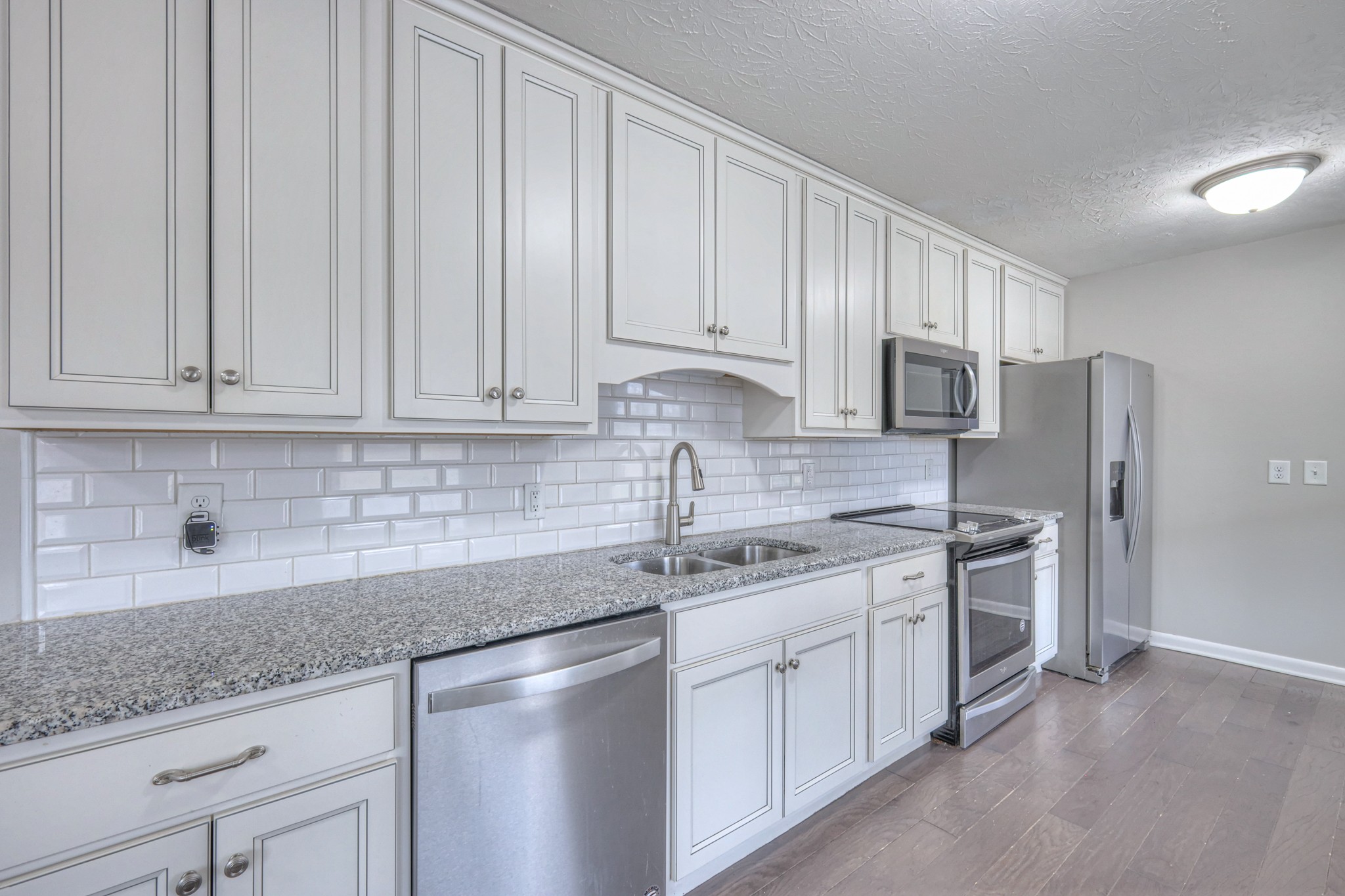 320 Ramsey Road Lebanon, TN 37087 - Photo 9 of 28 a kitchen with stainless steel appliances granite countertop a sink a stove a refrigerator and cabinets