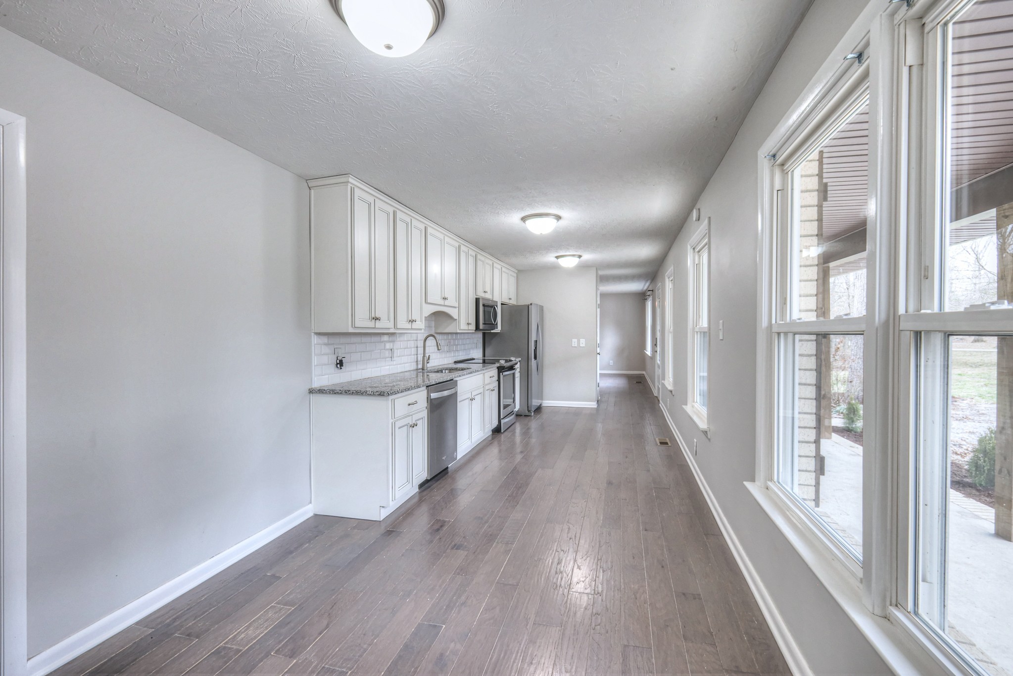 320 Ramsey Road Lebanon, TN 37087 - Photo 10 of 28 a view of a kitchen with wooden floor and a window