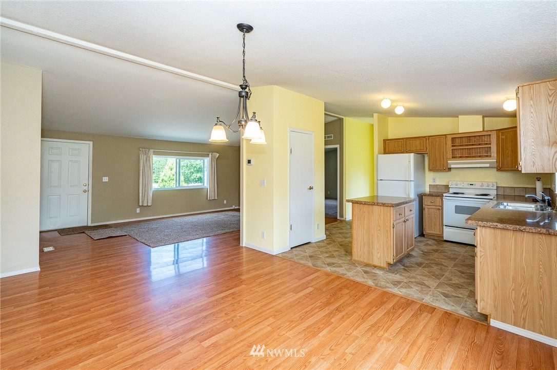 144 Hershel Road Chehalis, WA 98532 - Photo 7 of 40 a view of a kitchen with cabinets and wooden floor