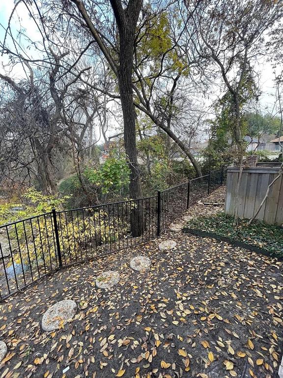 6315 Campbell Road, Unit 602 Dallas, TX 75248 - Photo 13 of 40 a view of a pathway with a wrought fence
