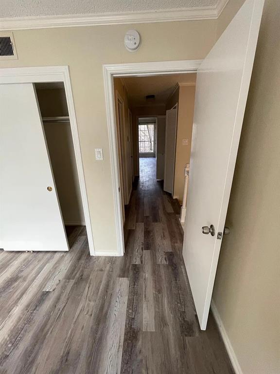 6315 Campbell Road, Unit 602 Dallas, TX 75248 - Photo 26 of 40 a view of a hallway with wooden floor and staircase