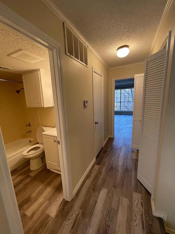 6315 Campbell Road, Unit 602 Dallas, TX 75248 - Photo 28 of 40 a view of a hallway with wooden floor and furniture