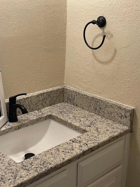 6315 Campbell Road, Unit 602 Dallas, TX 75248 - Photo 36 of 40 a bathroom with a granite countertop sink and a mirror