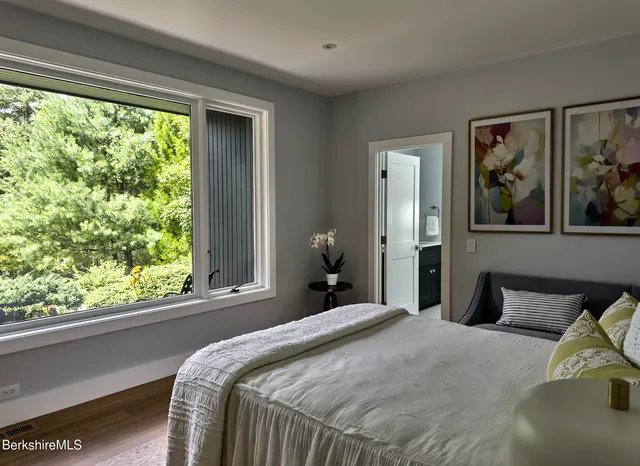 a bedroom with a bed and window