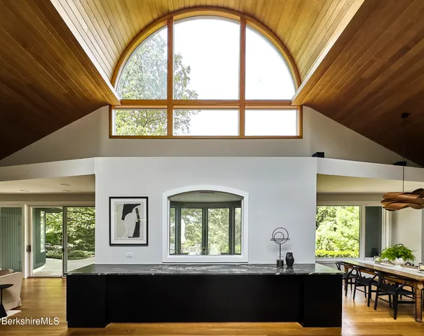 a living room with furniture a fireplace and wooden floor