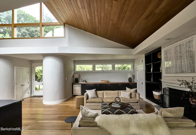 a living room with furniture a fireplace and a table