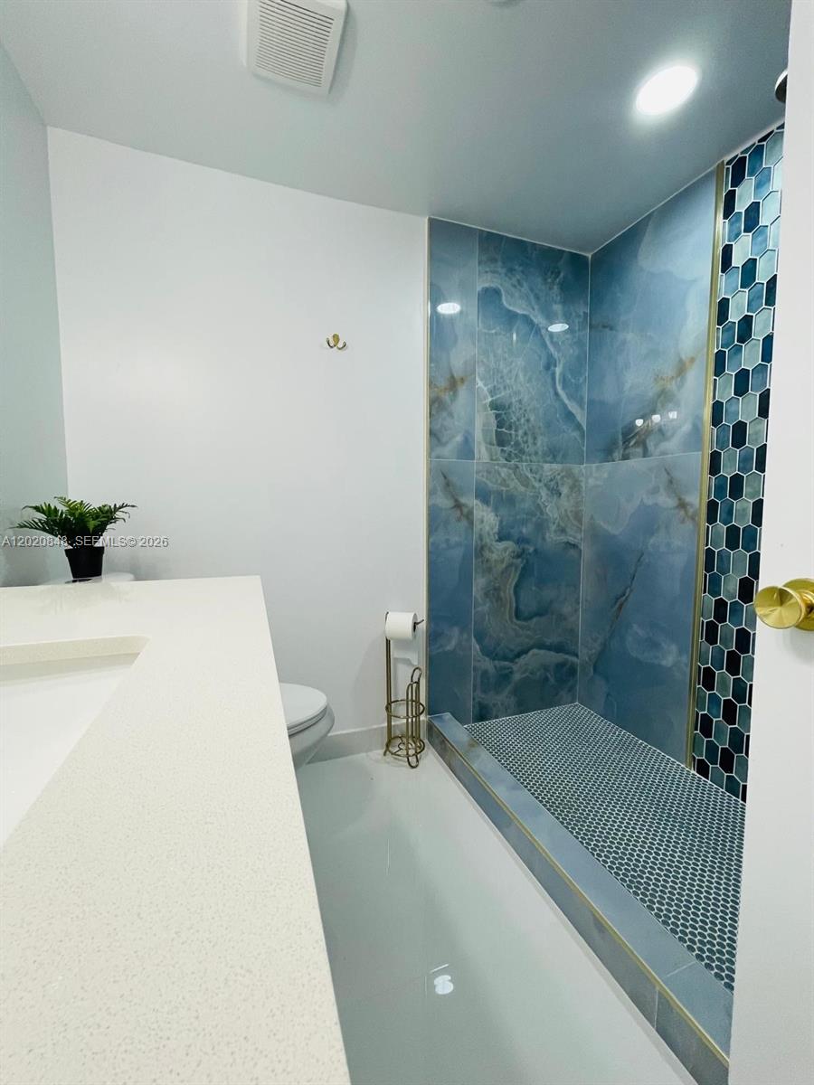 9175 Southwest 77th Avenue, Unit 306 Miami, FL 33156 - Photo 12 of 16 a bathroom with a tub and shower