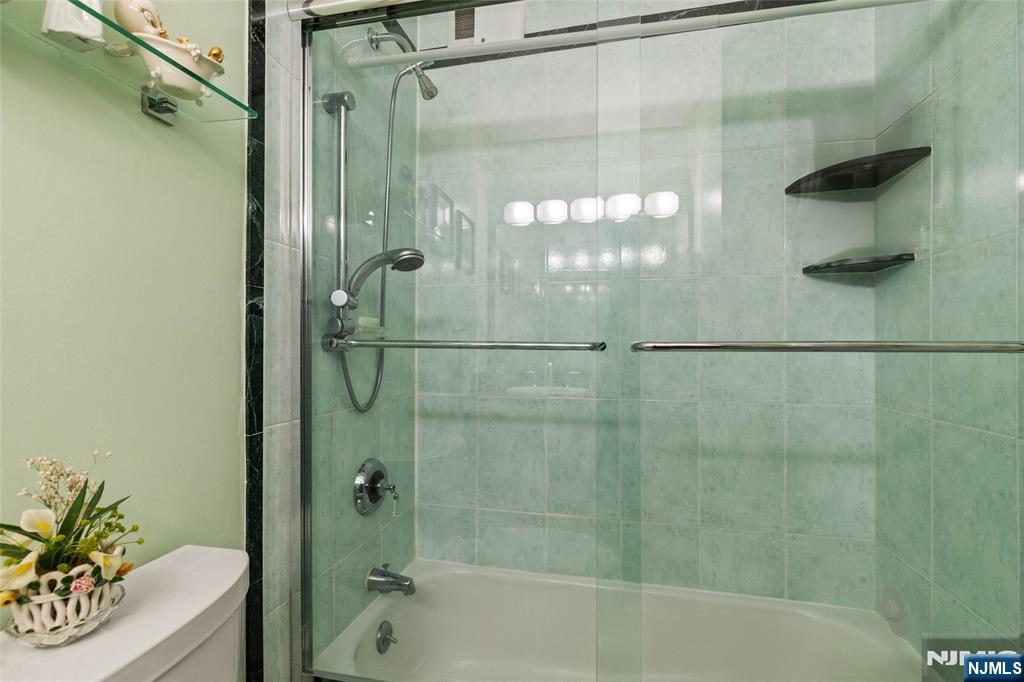 280 Prospect, Unit 9H Hackensack, NJ 07601 - Photo 12 of 37 a bathroom with a shower and a bath tub