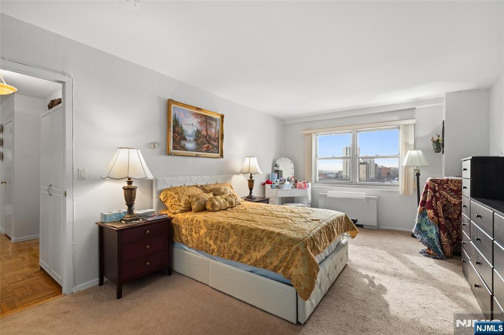 280 Prospect, Unit 9H Hackensack, NJ 07601 - Photo 16 of 37 a bedroom with a bed and a view of kitchen