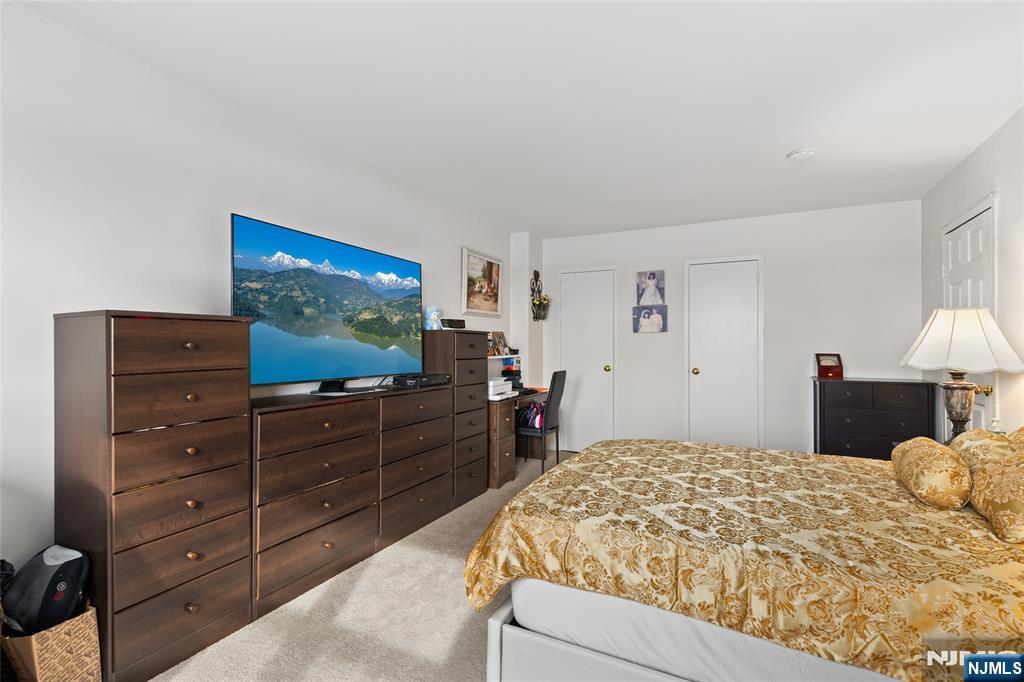 280 Prospect, Unit 9H Hackensack, NJ 07601 - Photo 17 of 37 a bedroom with a bed and a dresser