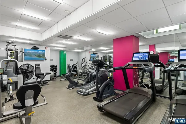 a room with gym equipment and windows