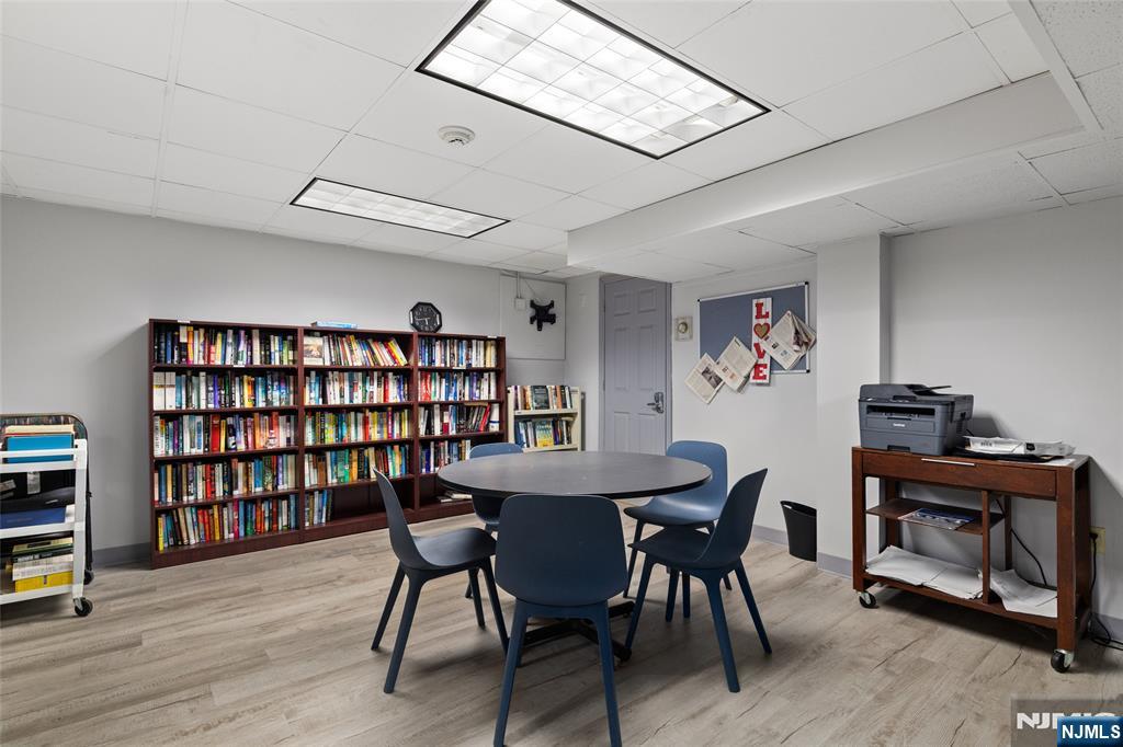 280 Prospect, Unit 9H Hackensack, NJ 07601 - Photo 23 of 37 a view of a workspace with furniture and wooden floor
