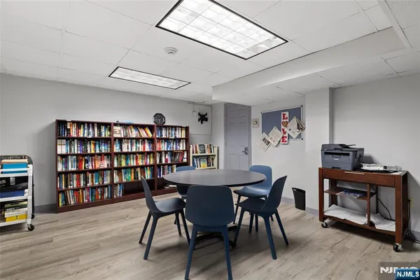 a view of a workspace with furniture and wooden floor