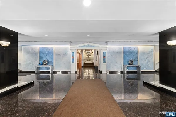 a lobby with furniture and flat screen tv
