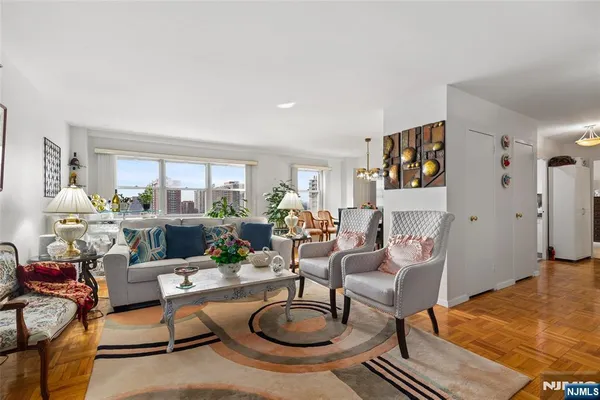 a living room with furniture a rug and a large window