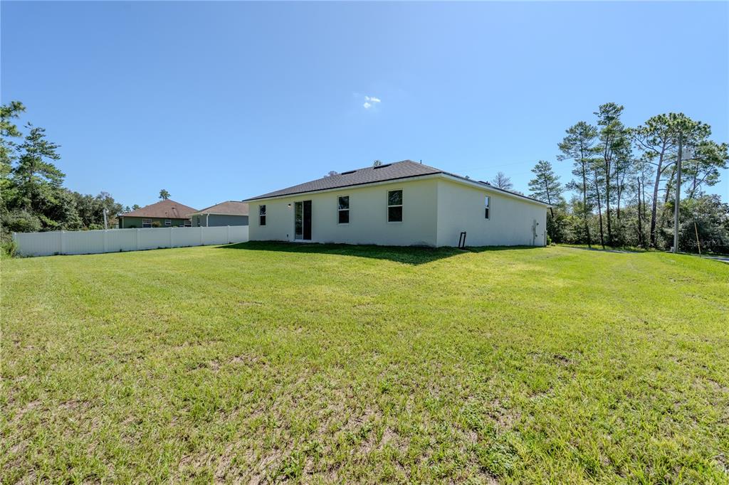 16038 Southwest 49th Court Ocala, FL 34473 - Photo 12 of 12 a large white building with a yard