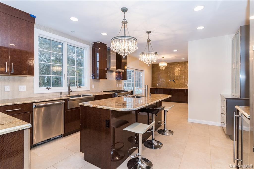 1 Elizabeth Road New Rochelle, NY 10804 - Photo 3 of 23 Kitchen with stainless steel appliances, wall chimney range hood, a sink, backsplash, and recessed lighting