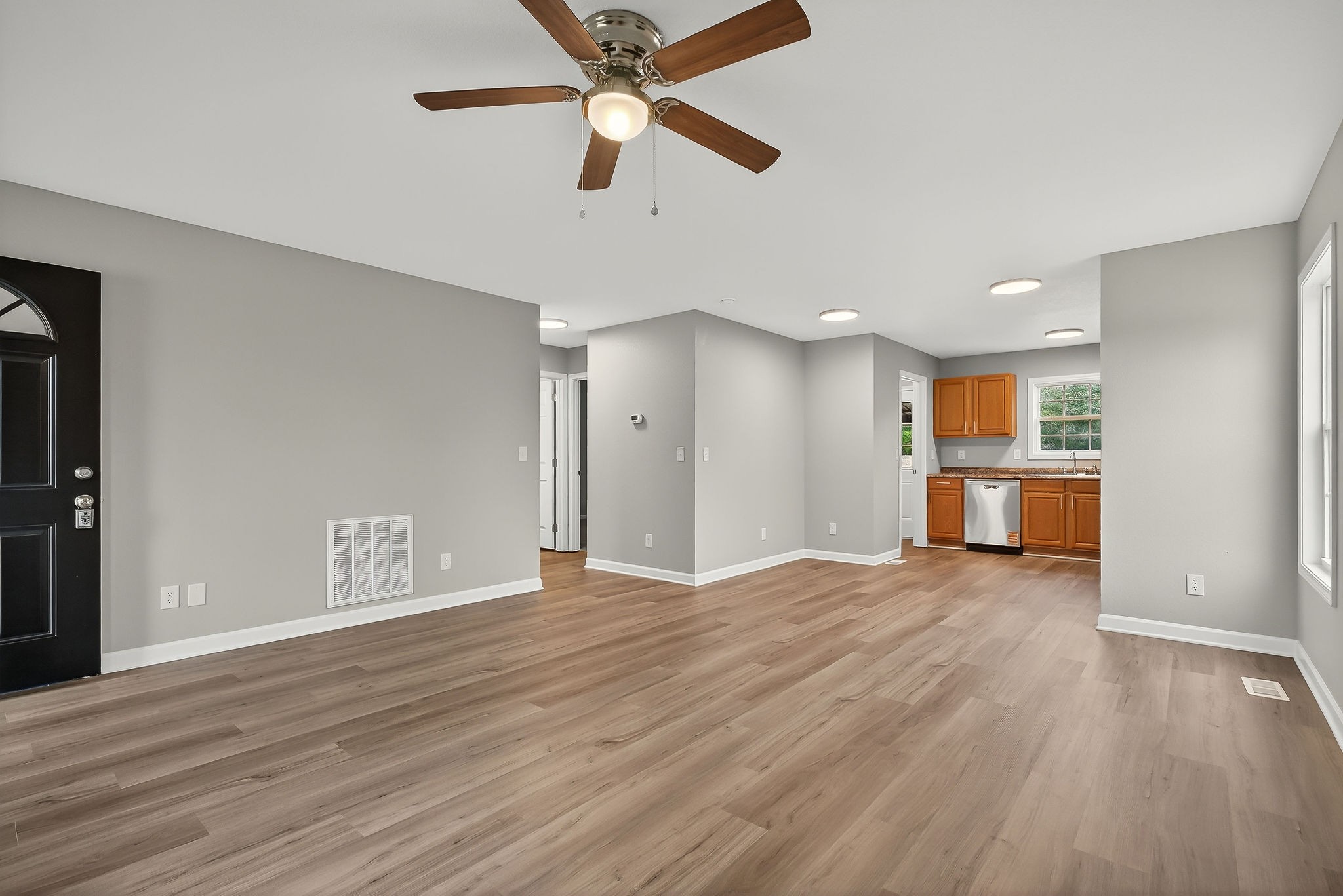 1193 Ashburn Road Monterey, TN 38574 - Photo 3 of 28 a view of an empty room with wooden floor and a ceiling fan