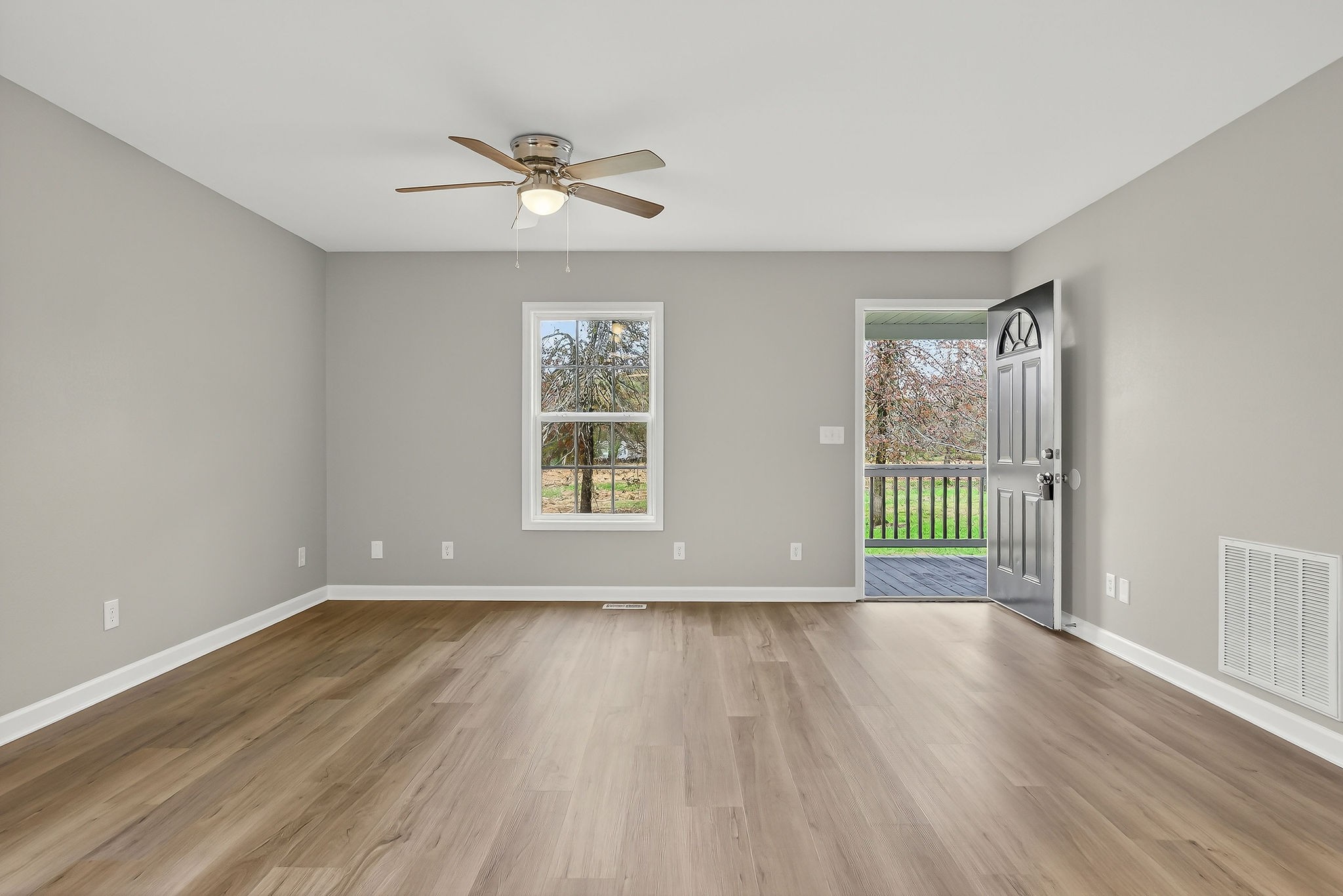 1193 Ashburn Road Monterey, TN 38574 - Photo 5 of 28 a view of an empty room with a window and wooden floor