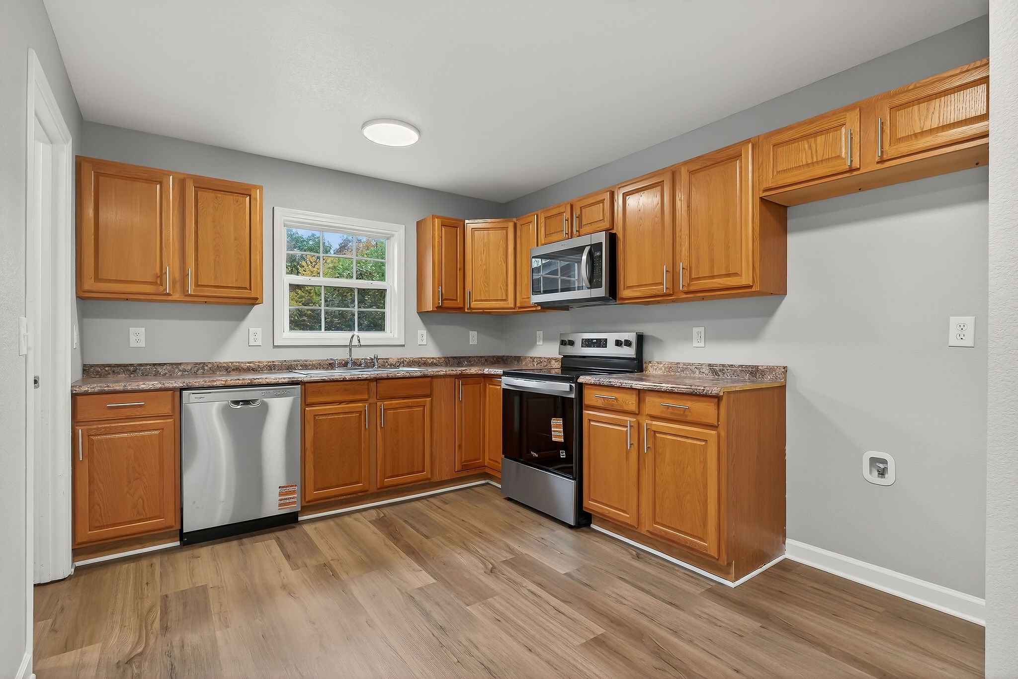 1193 Ashburn Road Monterey, TN 38574 - Photo 6 of 28 a kitchen with stainless steel appliances granite countertop a stove a sink and a microwave