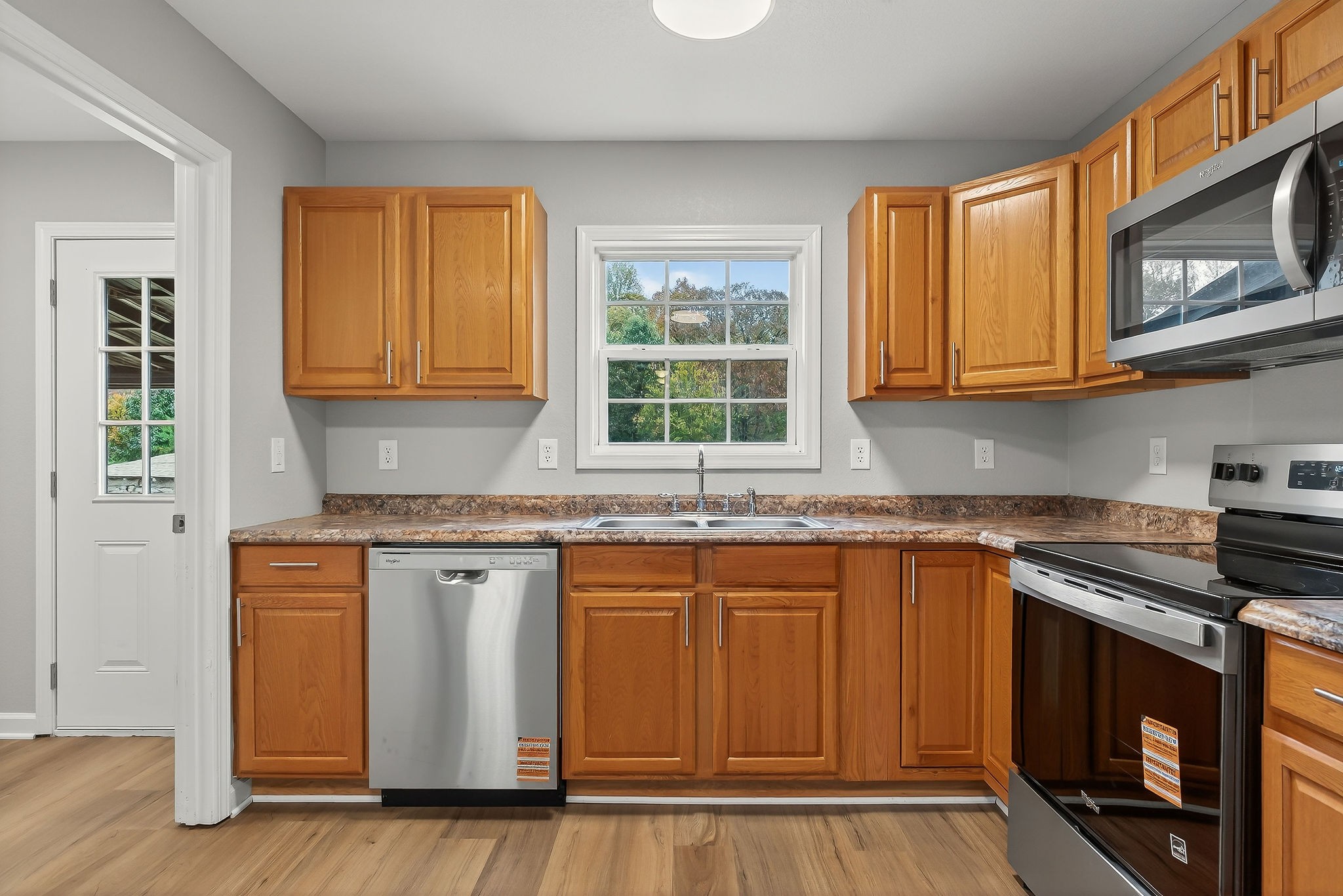 1193 Ashburn Road Monterey, TN 38574 - Photo 7 of 28 a kitchen with stainless steel appliances granite countertop a stove a sink and a microwave
