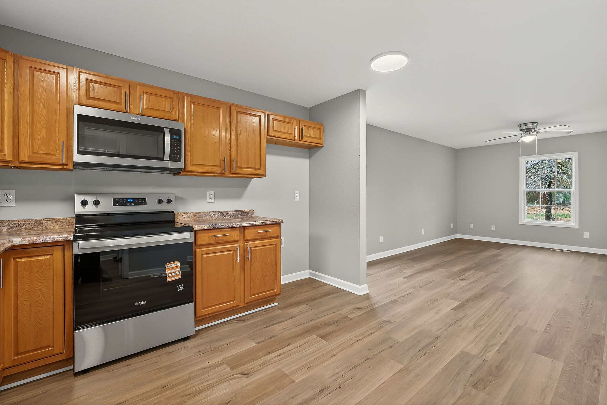 1193 Ashburn Road Monterey, TN 38574 - Photo 8 of 28 a kitchen with stainless steel appliances granite countertop a stove microwave and refrigerator