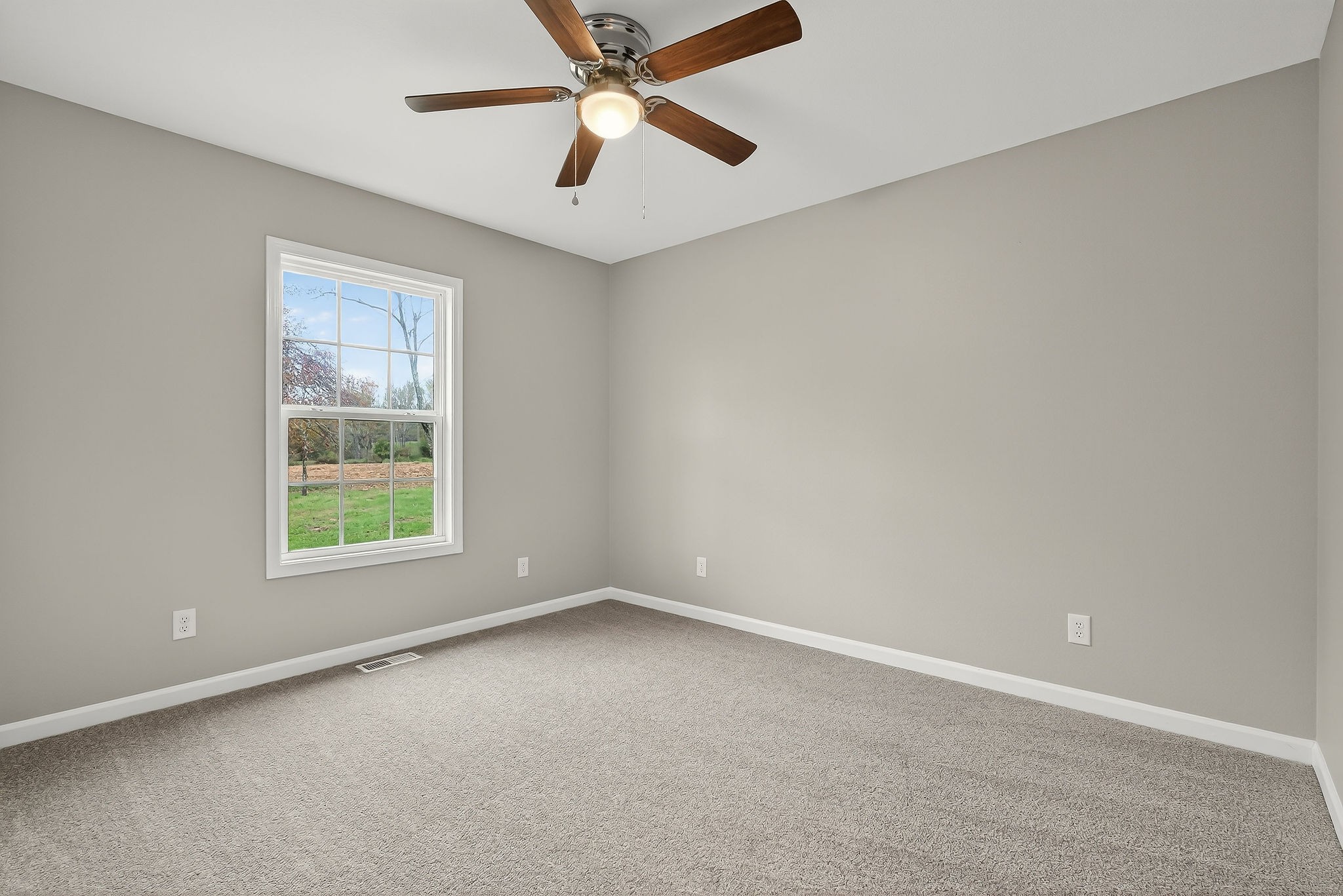 1193 Ashburn Road Monterey, TN 38574 - Photo 10 of 28 an empty room with a window and a fan