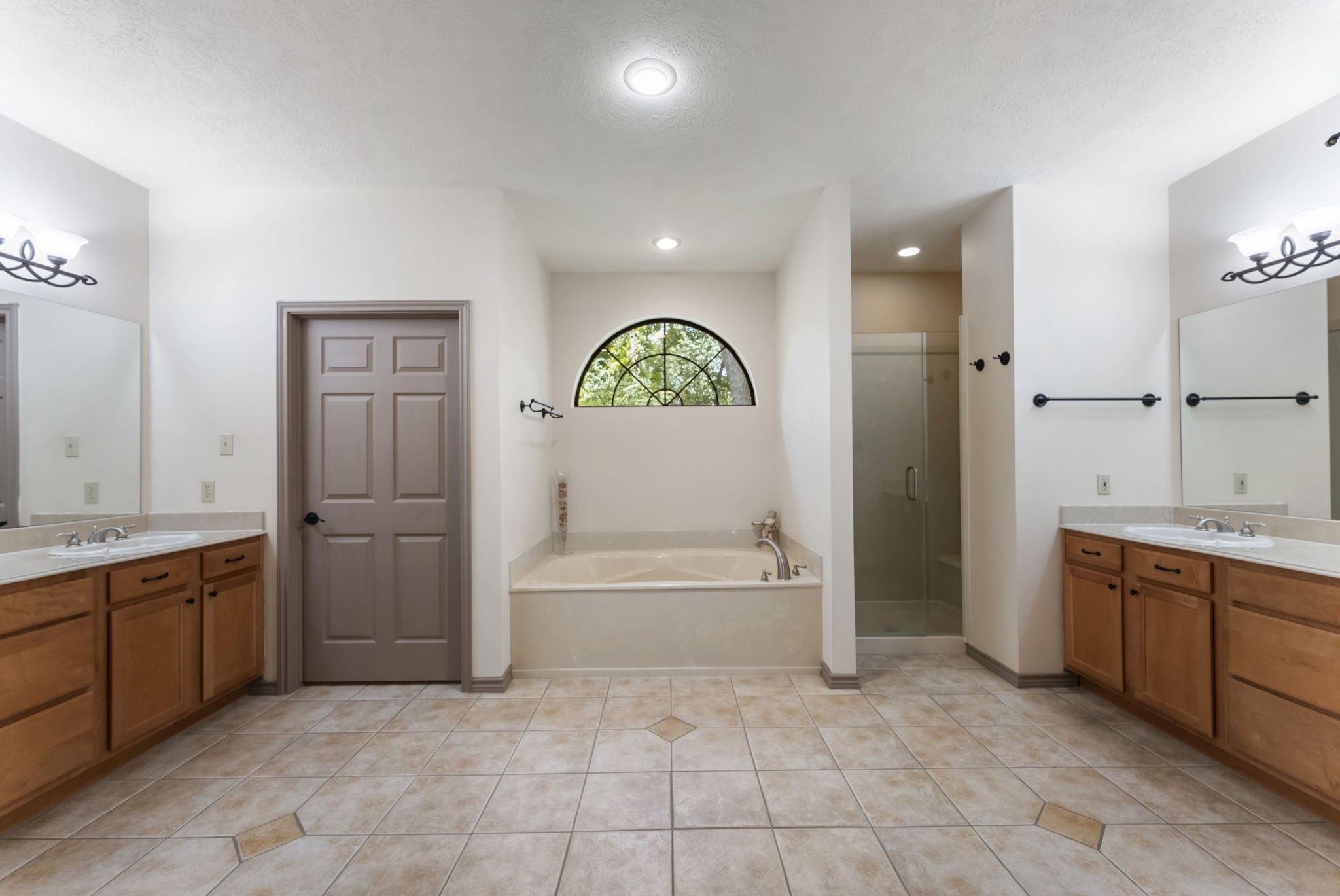 24311 Standing Oak Drive Spring, TX 77389 - Photo 29 of 42 a bathroom with a tub sink and mirror