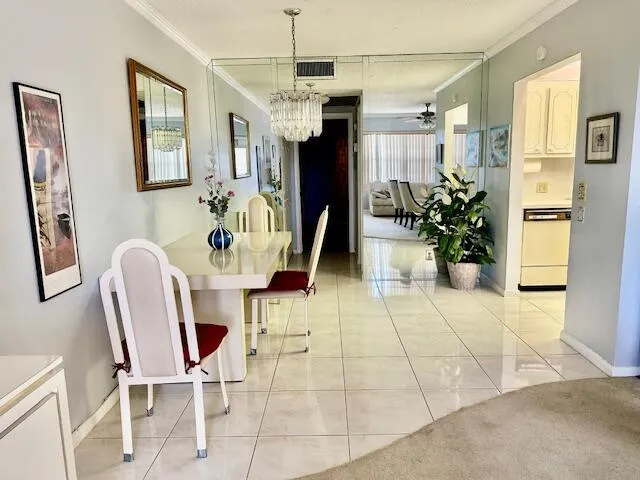 a view of a dining room with furniture and a chandelier