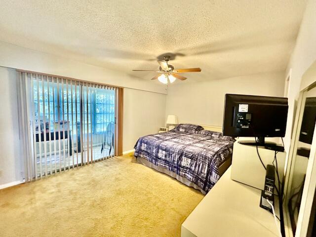 30 Suffolk A Boca Raton, FL 33434 - Photo 9 of 34 a bedroom with a bed and a chandelier