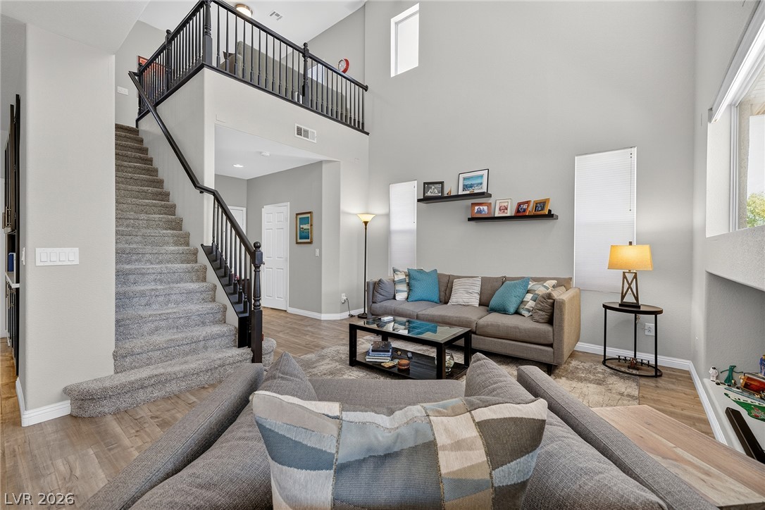 226 Priority Point Street Henderson, NV 89012 - Photo 19 of 32 Towering ceilings and a prominent staircase define this airy, open-concept living area.