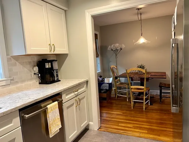 a kitchen with a sink cabinets and dining table