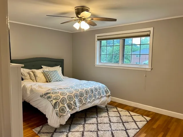 a bedroom with a bed and a window