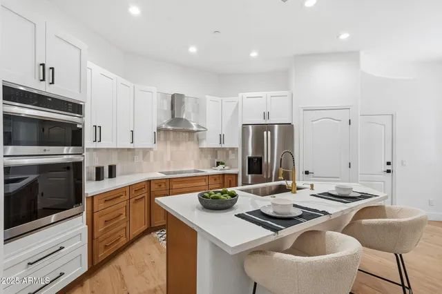 a kitchen with kitchen island a appliances counter space and a sink