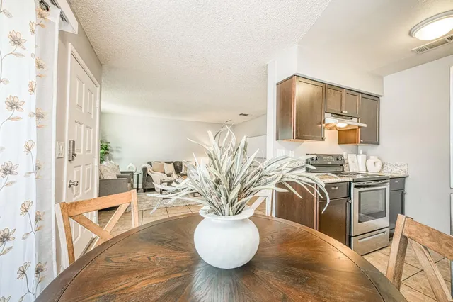 a view of living room with furniture and wooden floor