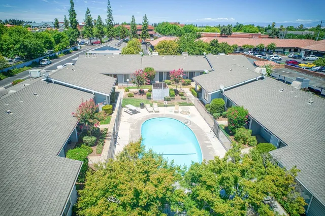 an aerial view of a house with a yard and garden