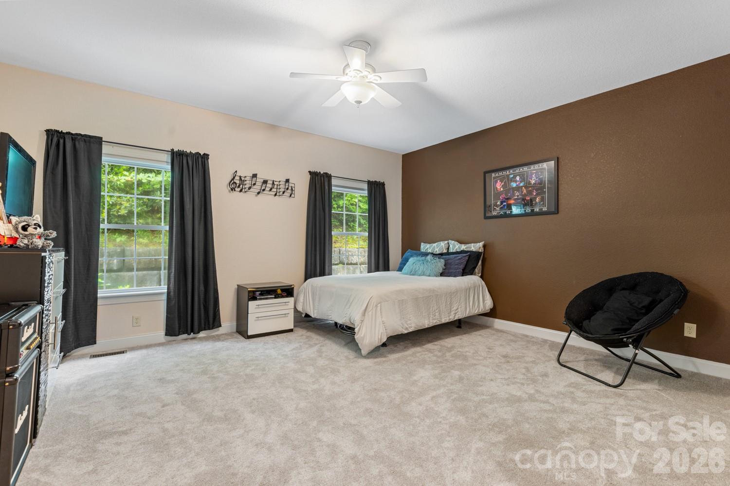 6 Grouse Terrace Fairview, NC 28730 - Photo 28 of 46 a bedroom with a bed a couch and a window