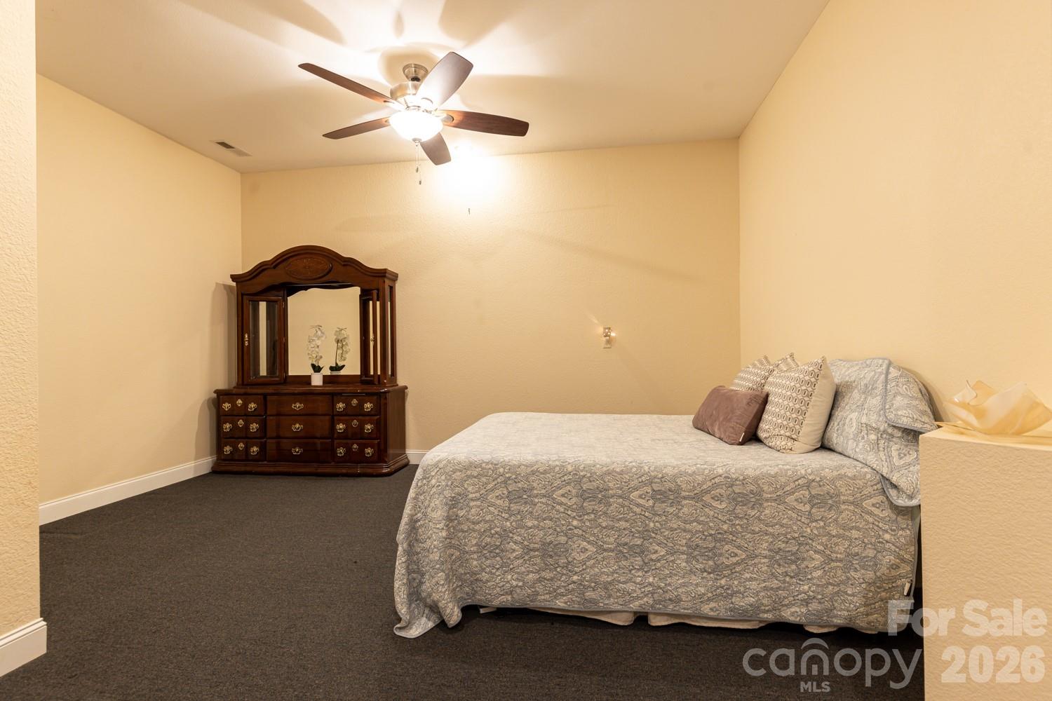 6 Grouse Terrace Fairview, NC 28730 - Photo 37 of 46 a bedroom with a bed and a chandelier