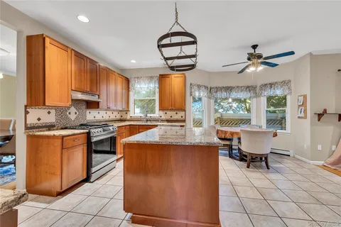 a kitchen with stainless steel appliances granite countertop a stove sink and cabinets