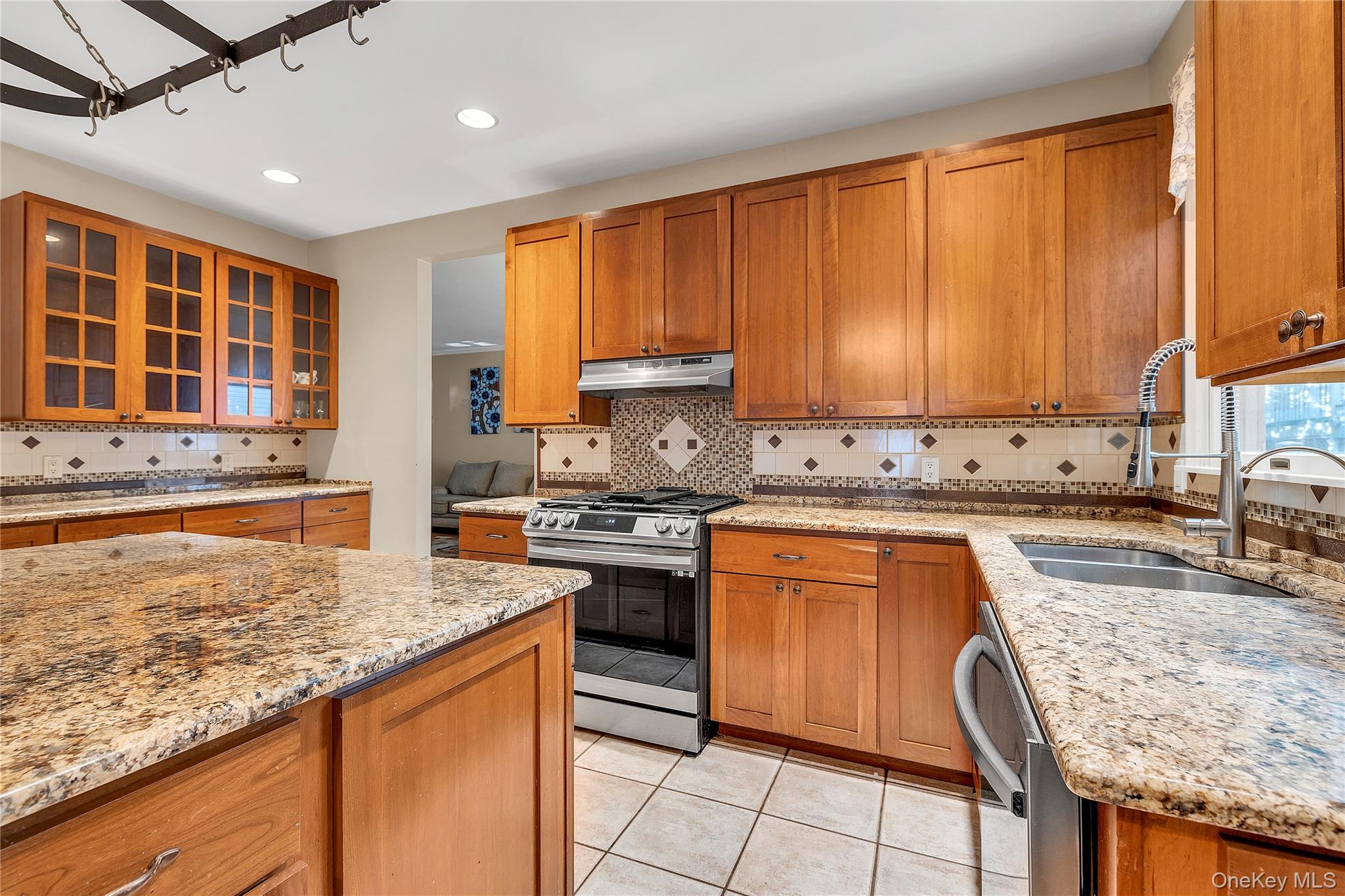 124 Fleets Cove Road Huntington, NY 11743 - Photo 13 of 35 a kitchen with stainless steel appliances granite countertop a stove sink and cabinets