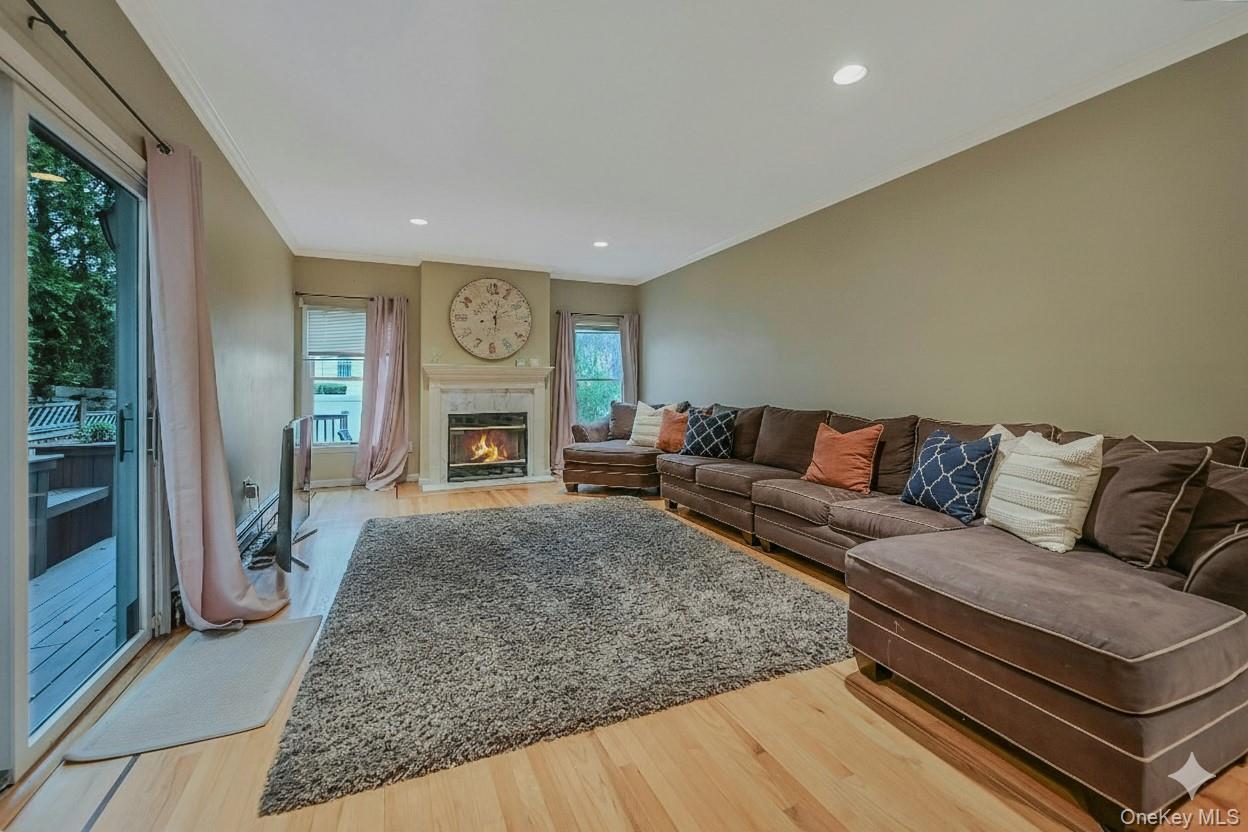 124 Fleets Cove Road Huntington, NY 11743 - Photo 15 of 35 a living room with furniture and a fireplace