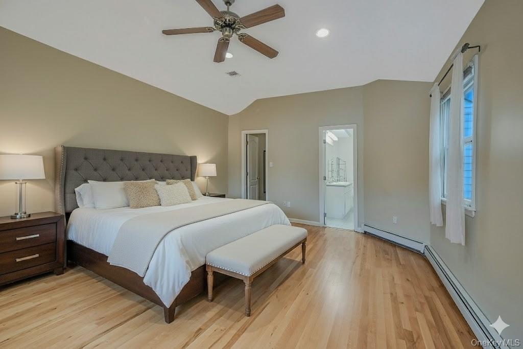 124 Fleets Cove Road Huntington, NY 11743 - Photo 18 of 35 a bedroom with a bed and wooden floor