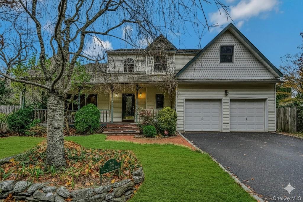 124 Fleets Cove Road Huntington, NY 11743 - Photo 2 of 35 a front view of a house with a yard and garage