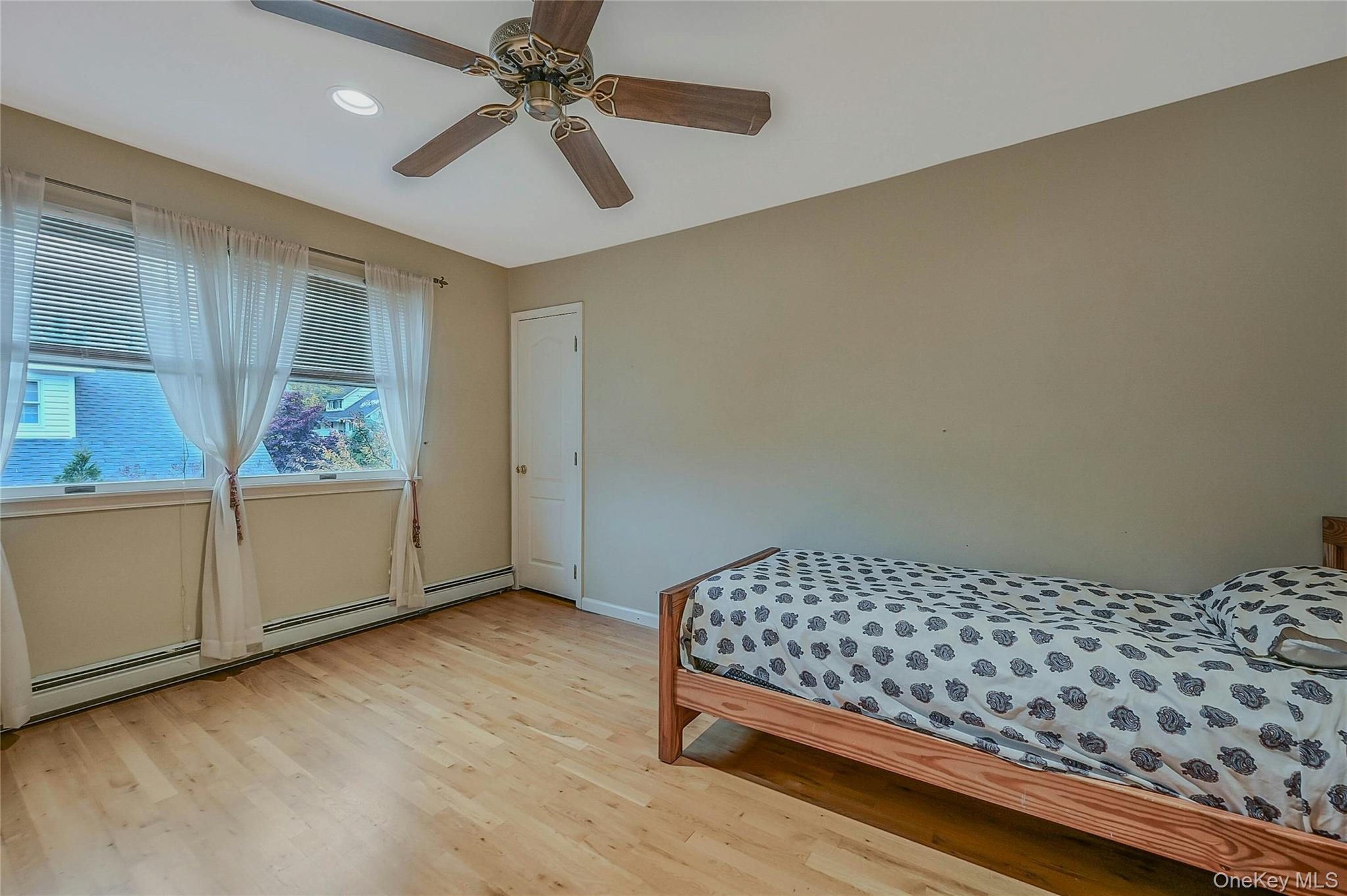 124 Fleets Cove Road Huntington, NY 11743 - Photo 23 of 35 a bedroom with a bed and wooden floor