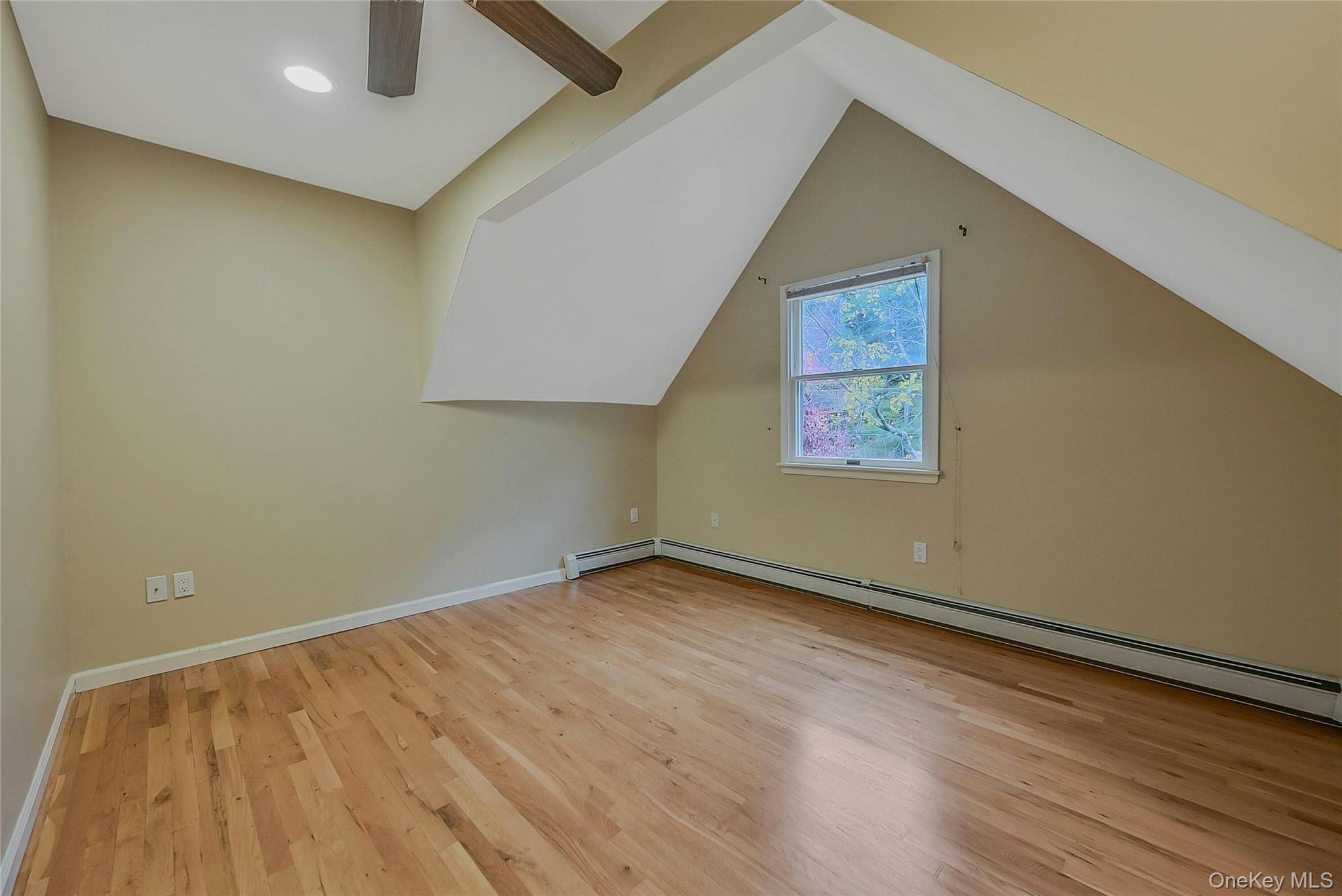124 Fleets Cove Road Huntington, NY 11743 - Photo 24 of 35 an empty room with wooden floor and windows