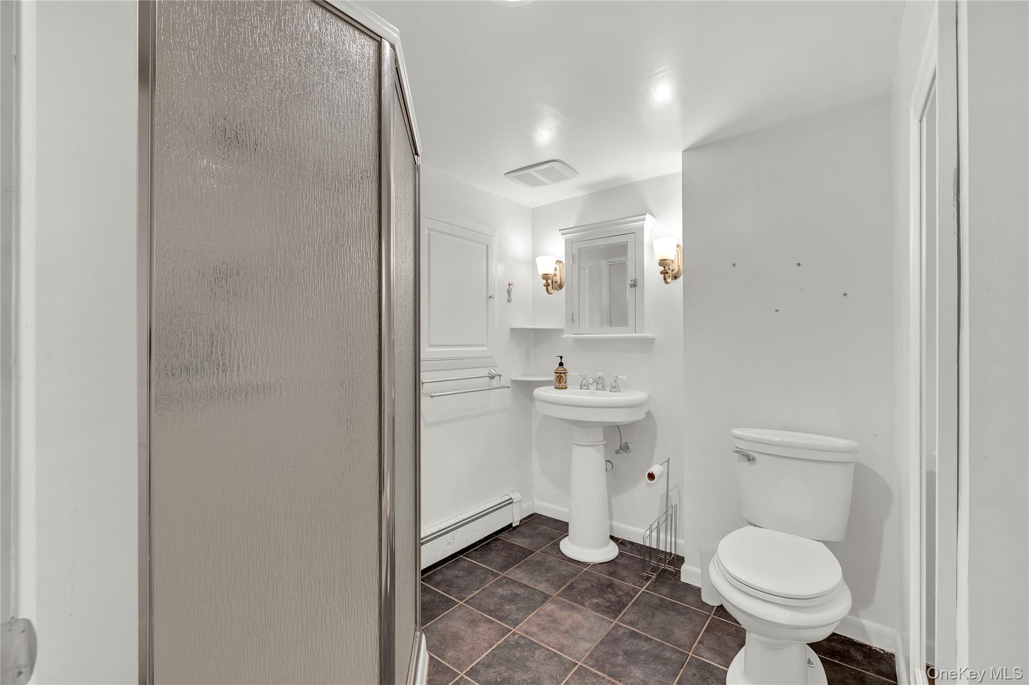 124 Fleets Cove Road Huntington, NY 11743 - Photo 28 of 35 a bathroom with a sink toilet and a mirror