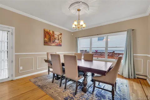 a kitchen with stainless steel appliances a refrigerator a stove a sink and chairs